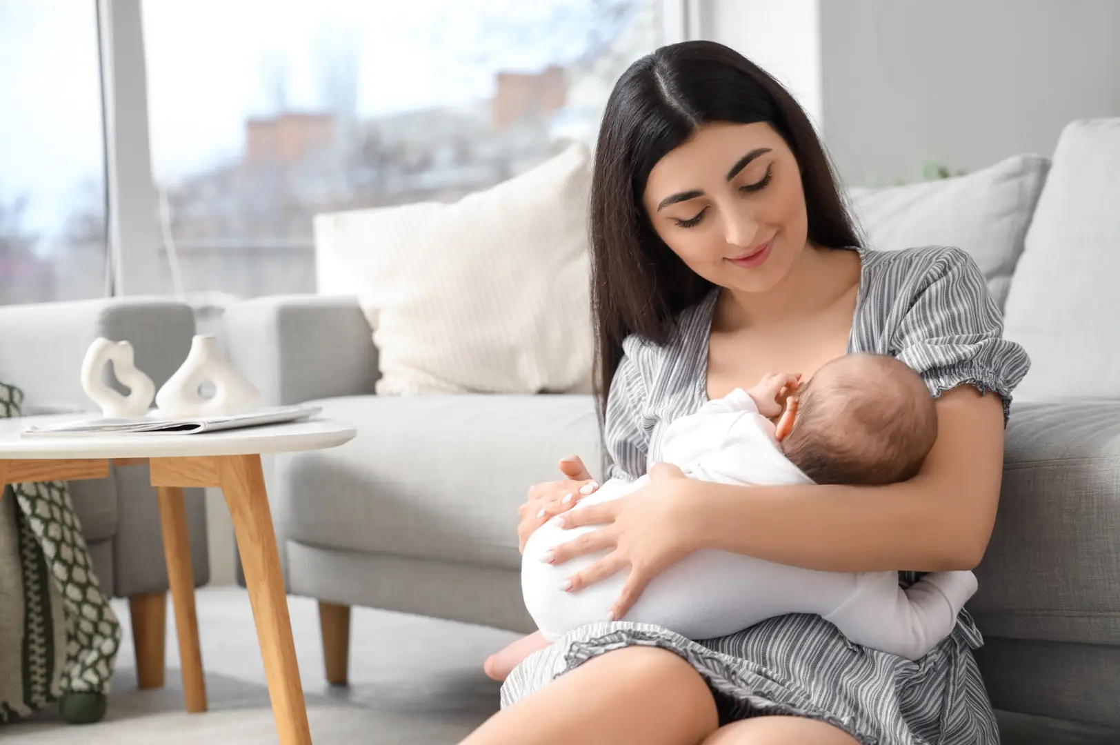 A mother with her newborn at home.